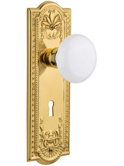 Meadows Door Set with White Porcelain Knobs and Keyhole Single Dummy in Polished Brass.